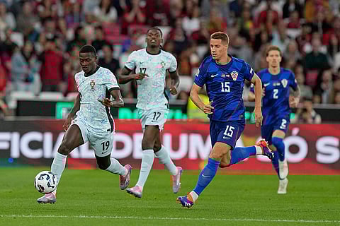 2024-25 Nations League Football Portugal vs Croatia: Portugal's Nuno Mendes, left, is chased by Croatia's Mario Pasalic